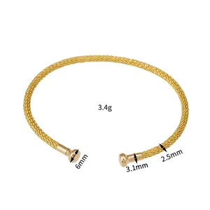 Handcrafted gold woven bangle featuring a minimalist open-end design and detailed textures