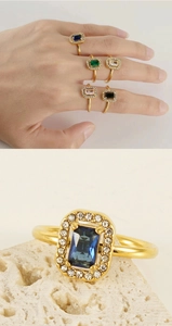 Close-up of gold-plated square gemstone ring with halo diamonds and five color options