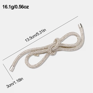 Detail view of a large gold rhinestone bow hair clip with 13.5cm length dimensions