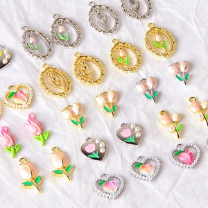 DIY jewelry charms featuring enamel tulip flowers, peaches and heart shapes in alloy