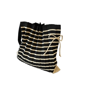 Chic black and beige striped knit pleated tote bag with drawstring bow detail