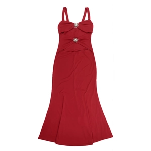 Detail of red fishtail dress featuring golden sun-shaped metal buckles on the waist