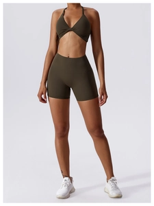 Front detail of dark olive green yoga set with twisted halter bra and high waist shorts