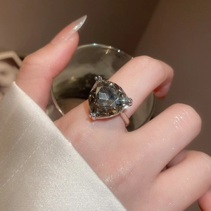 Detailed close-up of a large triangle-cut smoky grey gemstone ring with silver claws