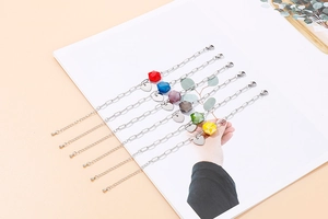Detail view of heart charm bracelets with colorful geometric beads and adjustable chain