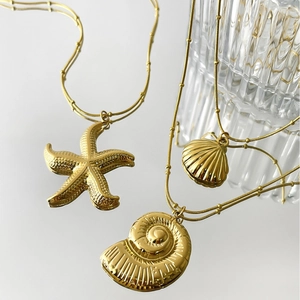Minimalist gold ocean theme necklaces with starfish shell and nautilus pendants
