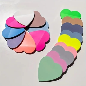 Colorful heart-shaped acrylic decorations arranged in artistic patterns on a white background