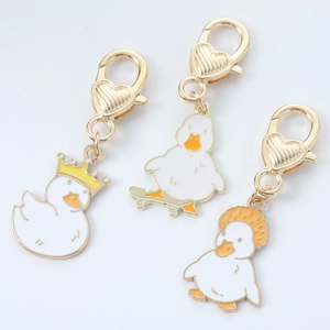 Cute cartoon duck keychains set with gold plated finish and colorful enamel charms