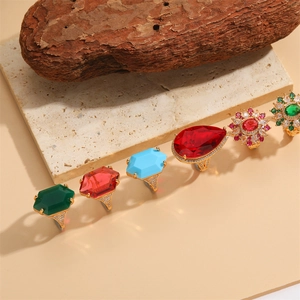 Luxury gold flower rings with colorful zircon and vintage gemstones on stone base