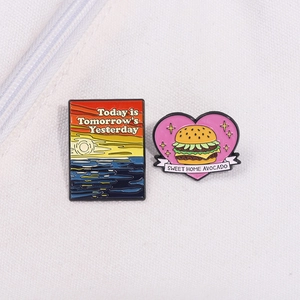 Cartoon burger and sunset enamel brooches with Today is Tomorrow's Yesterday text