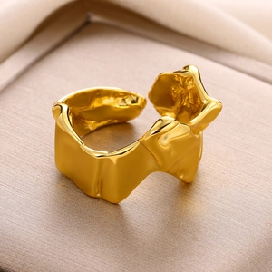 Macro shot of gold-plated open ring featuring a modern asymmetrical lava-flow texture