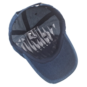 Internal detail of blue washed denim baseball cap showing black sweatband and stitching