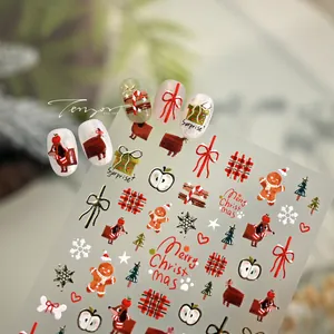 Detailed view of Christmas nail stickers featuring gingerbread men and festive patterns