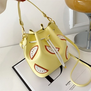 Yellow lemon-shaped bucket bag with drawstring closure and crossbody strap for women