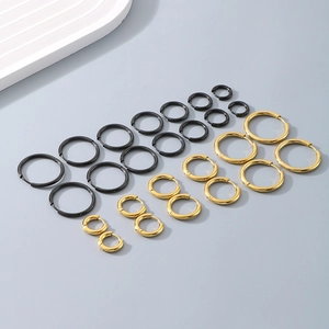 Detailed set of gold and black titanium steel hoop earrings in various sizes for women