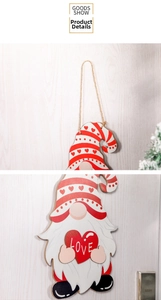 Detail of wooden gnome Christmas ornament with a red heart and LOVE lettering