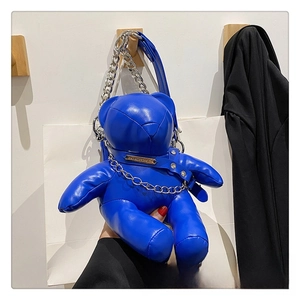 Detail of royal blue 3D bear shoulder bag in glossy PU leather with metallic chain strap
