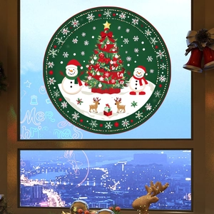 Detail of Christmas tree and snowman electrostatic window sticker on glass background