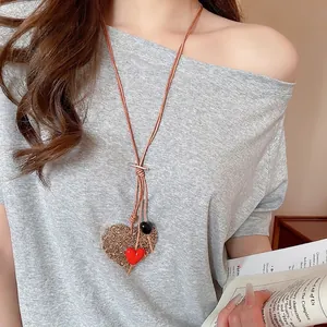 Bohemian acrylic heart pendant necklace with brown cord and hollow gold charm