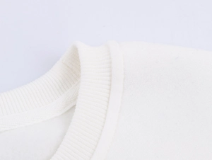 Detail of white sweatshirt crewneck with ribbed collar and soft fleece lining texture