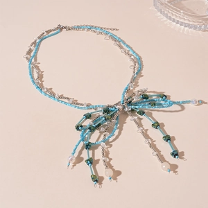 Double-layered beaded necklace with blue seed beads and silver butterfly pendant accent