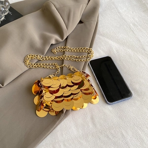 Chic mini gold sequin crossbody bag with chain strap shown alongside a smartphone
