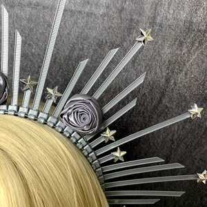 Macro view of a grey gothic crown headband with satin roses and zip tie sunburst rays
