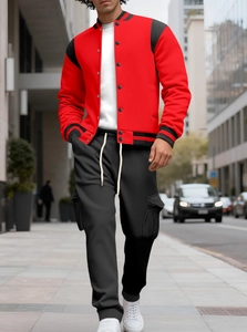 Low-angle street shot of a red varsity jacket with black drawstring cargo pants