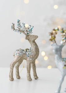 Close-up of glittery gold and silver Christmas reindeer ornaments with sparkling sequins