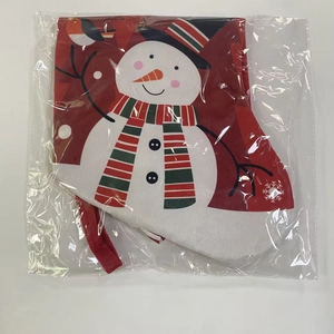 Detail of red Christmas stocking featuring a cartoon snowman with hat and scarf motif