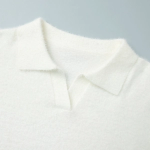 Detail of soft white knit polo sweater collar showing plush texture and fuzzy mohair fabric