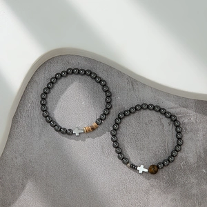Hematite beaded bracelet set with silver cross charms and tiger eye stone accents