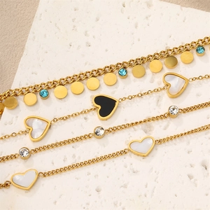 Elegant layered gold-tone titanium steel bracelets with heart pendants and crystal accents