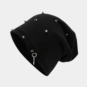 Close-up of hip hop knit beanie with silver punk metal rivets and a side hoop ring detail