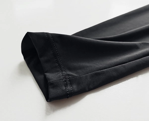 Detail of professional double-needle stitching on black elastic sleeve cuffs and hem