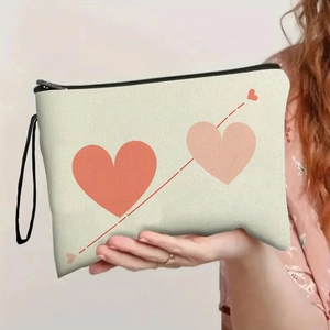 Minimalist beige canvas makeup bag with red and pink heart patterns and black zipper