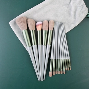 13pcs makeup brush set with beige pink bristles and dark green handles in a velvet pouch