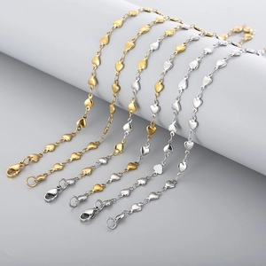 Detail of interlocking gold and silver heart-shaped links on stainless steel necklaces