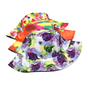 Three tie-dye and floral reversible bucket hats for sun protection in vibrant colors
