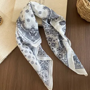 Vintage blue floral paisley scarf with sunflower pattern on white fabric and wooden base