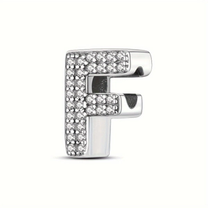 Detailed view of silver letter F charm bead with shimmering cubic zirconia micro-pave