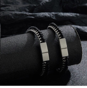 Detail view of double layer black braided leather bracelets with silver magnetic clasp