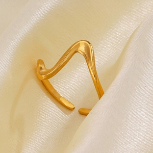 Minimalist gold irregular wave open ring on silk fabric background with 45-degree view