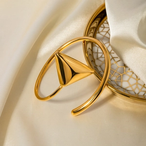 Minimalist 18k gold plated stainless steel triangle bangle on elegant white silk