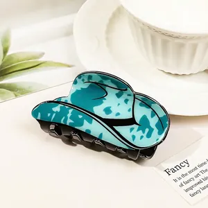 Macro detail of the creative cowboy hat claw clip with blue and black marble textures