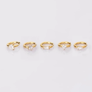 Macro shot of five gold stainless steel hoop earrings with multi-shaped zircon inlays