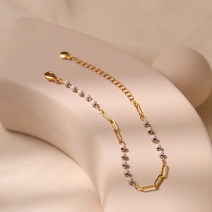 Minimalist gold beaded bracelet with white synthetic turquoise and lobster clasp design