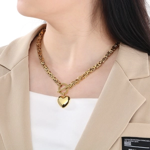 Close-up of 18K gold plated heart necklace with Byzantine chain and OT toggle clasp