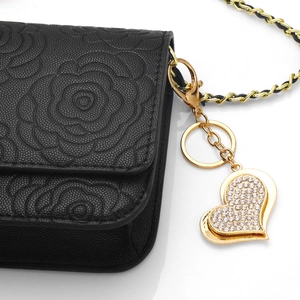 Black litchi grain leather mini bag with camellia embossing and heart crystal keychain