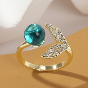 Golden mermaid tail ring with green crystal and diamonds, adjustable open design